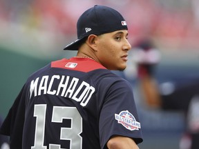 American League, Baltimore Orioles shortstop Manny Machado looks over his shoulder as he walks onto the field before the Major League Baseball All-star Game, Tuesday, July 17, 2018 in Washington.