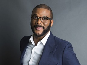 FILE - In this Nov. 16, 2017, file photo, actor-filmmaker and author Tyler Perry poses for a portrait in New York to promote his book, "Higher Is Waiting." Perry is warning fans not to be scammed. The actor, comedian and director in a video says he's not giving away anything on Facebook.