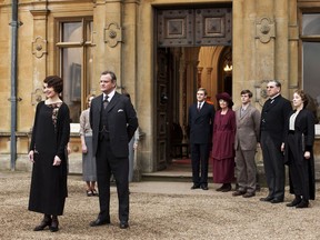 This undated publicity photo provided by PBS shows, from left, Elizabeth McGovern as Lady Grantham, Hugh Bonneville as Lord Grantham, Dan Stevens as Matthew Crawley, Penelope Wilton as Isobel Crawley, Allen Leech as Tom Branson, Jim Carter as Mr. Carson, and Phyllis Logan as Mrs. Hughes, from the TV series, "Downton Abbey." Focus Features said Friday, July 13, that it will this summer begin production on a "Downton" film that will reunite the Crawley family on the big screen. Series creator Julian Fellowes wrote the screenplay and will produce.
