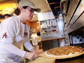 In this Dec. 27, 2017, file photo, employee Marena Loqa makes a pie at Antonino's Original Pizza Inc. The pizza parlour on Howard Avenue in South Windsor is now expanding.