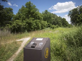 A trash receptacle at the entrance to the Ojibway Prairie Provincial Nature Reserve, where mounds of trash were discovered, is seen on July 17, 2018.