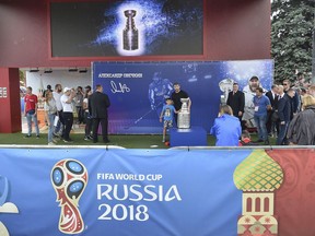 Washington Capitals Alex Ovechkin, from Russia, center, poses with the Stanley Cup trophy in the fan zone in Moscow ahead of the the quarterfinal match between Russia and Croatia at the 2018 soccer World Cup that is being played in the Fisht Stadium, in Sochi, Russia, Saturday, July 7, 2018. Ovechkin is bringing the Stanley Cup to the World Cup. Fresh off winning the NHL title, the Washington Capitals forward is taking the trophy to Moscow on Saturday, where it will be exhibited at a "fan fest" public viewing site ahead of Russia's quarterfinal game against Croatia.