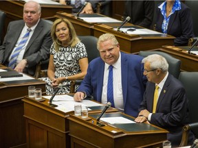 Ontario Premier Doug Ford (middle) along with Deputy Premier Christine Elliott and Minister of Finance Vic Fedeli (right) are shown during the Throne speech at the Legislative Chamber at Queen's Park on July 12, 2018.