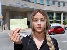 Karly Robinson displays a list of fines on Tuesday, July 24, 2018, given to her by Windsor Police. She says someone gave police her name during a recent traffic stop and all the infractions are now her responsibility to dispute.