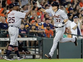 Detroit Tigers' Jim Adduci (37) is congratulated by third base coach Dave Clark (25) after hitting a home run against the Houston Astros during the sixth inning of a baseball game Sunday, July 15, 2018, in Houston.