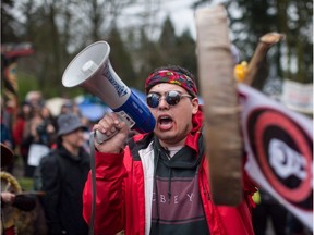 Cedar George-Parker addresses the crowd as protesters opposed to the Kinder Morgan Trans Mountain pipeline extension defy a court order and block an entrance to the company's property, in Burnaby, B.C., on April 7, 2018.