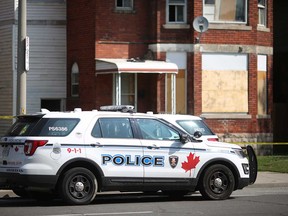 A Windsor police vehicle in front of the duplex in the 1300 University Avenue West where a violent dispute occurred on July 11, 2018.