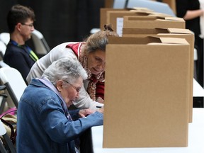 In this Oct. 11, 2014, file photo from the last municipal election year, people vote at Shop and Vote at Devonshire Mall during the first advance poll of the Windsor civic elections.