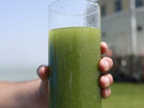 In this Aug. 3, 2014 file photo, a sample glass of Lake Erie water is photographed near the City of Toledo water intake crib on Lake Erie. (File photo)