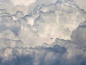 A plane flies around a thunderstorm over Windsor on August 3, 2017.