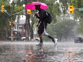 Environment Canada warns of potentially heavy rainfall overnight Tuesday to Wednesday. In this Aug. 29, 2017, a Windsor pedestrian has the right idea, armed with an umbrella.