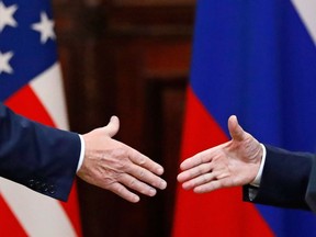 U.S. President Donald Trump shakes hand with Russian President Vladimir Putin at the end of the press conference after their meeting at the Presidential Palace in Helsinki, Finland, Monday, July 16, 2018.