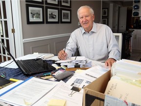 Karl Straky, spokesman for the group Citizens for Healthcare Windsor-Essex, sorts through paperwork and files at his dining room table on Thursday, Aug. 2 2018. The group is working to get the new mega-hospital approved and constructed.