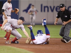 TORONTO, ON - AUGUST 9: Yangervis Solarte #26 of the Toronto Blue Jays is caught stealing second base as Brock Holt #12 of the Boston Red Sox tags him out in the fifth inning during MLB game action at Rogers Centre on August 9, 2018 in Toronto, Canada. (Photo by Tom Szczerbowski/Getty Images) ORG XMIT: 775136985