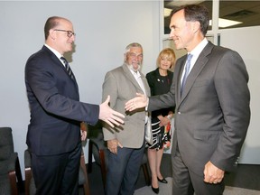Federal Finance Minister Bill Morneau, right, visits the Windsor-Essex Regional Chamber of Commerce on Aug. 13, 2018. In photo, Morneau is greeted by Windsor Mayor Drew Dilkens, Essex County Warden Tom Bain and interim Chamber president Janice Forsyth.