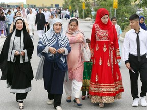 Eid Al-Adha participants Mahnoz Akhtari, left, Maliha Popalzai, Nahib Abdul Ghanan, Farahnaz Akhtari, behind, Fatima Akhtari and Omeed Akhtari, right, leave the Windsor Islamic Association prayer service at Central Park Athletics August 21, 2018. About 7,000 attended two prayers at Central Park. Eid Al-Adha is the holiday of sacrifice.  Local and visiting Muslims celebrated at several area locations throughout the day.