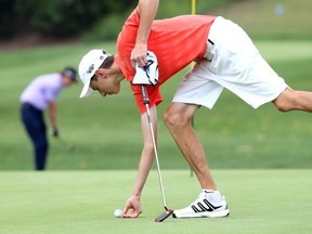 Alek Mauro marks his ball on Roseland's 10th green during the Senior Division Championship Flight of the Essex-Kent Golf Championship on Aug. 22, 2018.