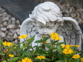 An angel and flowers are shown in this photo illustration of a cemetery.