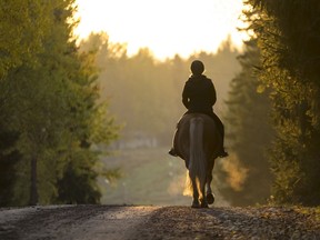 A woman is seen  riding on a road in this photo illustration.