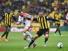 Crystal Palace's Scottish midfielder James McArthur (L) vies with Watford's German-born Greek midfielder Jose Holebas during the English Premier League football match between Watford and Crystal Palace at Vicarage Road Stadium in Watford, north of London on August 26, 2018.