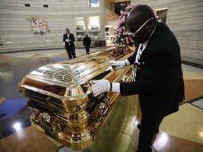 Vincent Street wipes down the casket of legendary singer Aretha Franklin at the Charles H. Wright Museum of African American History in Detroit on Aug. 29, 2018. Franklin died Aug. 16, 2018 of pancreatic cancer at the age of 76.