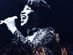 Madonna presents a tribute to Aretha Franklin, pictured on screen, at the MTV Video Music Awards at Radio City Music Hall on Monday, Aug. 20, 2018, in New York.