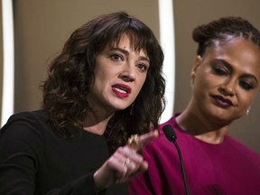 FILE - In this May 19, 2018 file photo, actress Asia Argento speaks about being raped by Harvey Weinstein as director Ava Duvernay looks on at right during the closing ceremony of the 71st international film festival, Cannes, in France. Argento, one of the most prominent activists of the #MeToo movement against sexual harassment, recently settled a complaint filed against her by a young actor and musician who said she sexually assaulted him when he was 17, the New York Times reported.