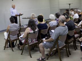 Lawyer Paul Mullins goes over his report on the efforts to save Assumption Church to parish members  in the basement at Holy Name of Mary Church, on Aug. 12, 2018.