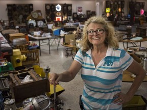 Brenda Lacasse, of Lacasse Auctions, stands among the many unique items set to be sold during the estate auction of the late Ron Onuch of Windsor, Thursday, August 16, 2018.