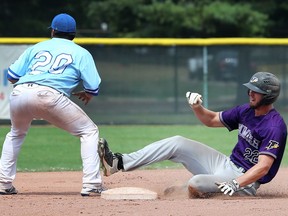 Ross Barker, of the Tecumseh Thunder slides safely into second base, on a double as   Antolin Morales of Strathroy waits for the outfield throw during their game at the Cullen Stadium on Monday. The game was suspended shortly afterwards and pushed to Saturday due to weather.