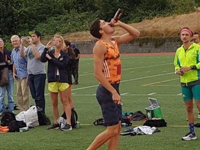 Corey Bellemore chugs a beer during the Beer Mile competition in Vancouver earlier this month.