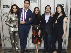 FILE: In this Aug. 14, 2018, file photo, Actors Michelle Yeoh, from left, Henry Golding, Constance Wu, Ken Jeong and Awkwafina participate in the BUILD Speaker Series to discuss the film "Crazy Rich Asians" at AOL Studios in New York. The craze for "Crazy Rich Asians" is hitting Asia, with a premiere in Singapore to be followed by openings in several neighboring countries later this week. Much of the movie was set in the wealthy city-state and the red carpet premiere Tuesday night for the over-the-top romantic comedy was expected to draw an enthusiastic crowd after its box-office bonanza in the U.S. Critics say its satirical portrayal of an uber-rich Singaporean Chinese family fails to showcase the city's ethnic diversity.