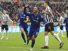 Chelsea's Eden Hazard, centre, celebrates scoring his side's first goal of the game against Newcastle, during their English Premier League soccer match at St James' Park in Newcastle, England, Sunday Aug. 26, 2018. (Owen Humphreys/PA via AP) ORG XMIT: LON828