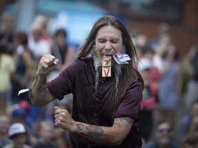 Sweet Pepper from the Monsters of Schlock has his tongue in a mouse trap and a $10 bill stapled to his face as he performs at the Walkerville Buskerville Festival on Aug. 11, 2018.