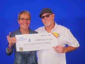 Lauri and Charles Caron of Windsor receive their prize cheque after winning the top prize on a game of Instant Cash For Life, Aug. 3, 2018.
