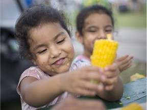 What it's all about. Melissa Garcia, 4, along with twin sister Rosemary, enjoy corn on the cob at the Tecumseh Corn Festival on Aug. 25, 2018.