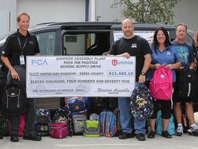 Fiat Chrysler Automobile's Windsor Assembly Plant workers pose for a photo on Aug. 27, 2018, after raising almost $11,500  to buy school supplies for needy children in the "Pack the Pacifica" fundraiser.