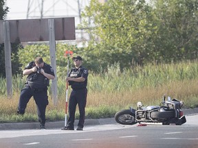 Windsor police accident reconstruction specialists examine the scene at Central Avenue and Grand Marais Road East where a collision involving a motorcycle had fatal consequences on Aug. 14, 2018.