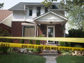Police tape surrounds the home at 1503 Gladstone Ave. on Aug. 15, 2018.