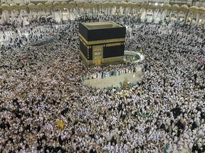 Muslim pilgrims perform the tawaf-e-ifadha circling of the Kaaba, during the annual Hajj pilgrimage on the first day of Eid al-Adha in Mecca, Saudi Arabia, on Aug. 21, 2018.