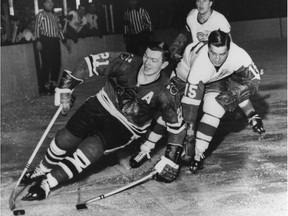 CORRECTS CREDIT TO AP Chicago Blackhawks Stan Mikita pulls away from Detroit Red Wings' Ted Lindsay during an NHL game in Chicago, Feb.24, 1965. Mikita, a nine-time all-star who played his entire NHL 21-year career with the Chicago Blackhawks, has died at age 78. THE CANADIAN PRESS/AP ORG XMIT: CPT132