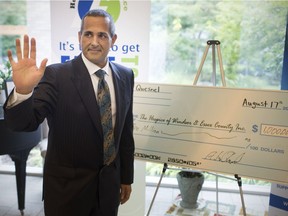 Local philanthropist, Al Quesnel, signs a cheque for $1 million for Hospice of Windsor and Essex County during a presentation at The Hospice on Friday, August 17, 2018.