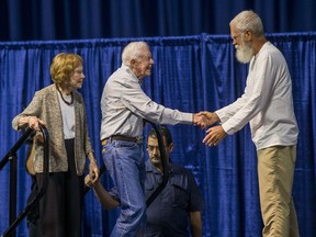 Former late night television host David Letterman, right, welcomes former President Jimmy Carter and his wife, former first lady Rosalynn Carter, to the stage during the opening ceremony for the Jimmy & Rosalynn Carter Work Project, Sunday, Aug. 26, 2018, inside the University of Notre Dame's Purcell Pavilion in South Bend, Ind.