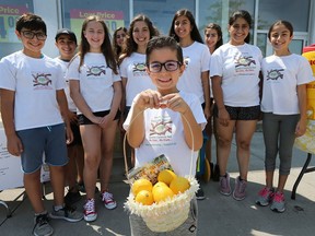 The 6th annual "Maya's Friends" fundraiser to help community food banks and the Ronald McDonald House was held at the at the Real Canadian Superstore on Walker Road in Windsor on Friday, August 10, 2018. The youngsters were offering fresh squeezed lemonade for a can of food donation. Noah Houad, 6, foreground, along with event organizer Maya Mikhail and other friends pose for a photo at the event.