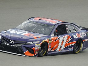 Denny Hamlin qualifies for a NASCAR Cup Series auto race at Michigan International Speedway in Brooklyn, Mich., Friday, Aug. 10, 2018. Hamlin won the pole position.