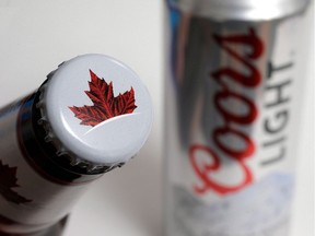 In this Nov. 28, 2017, file photo products from the Mondelez International family of brands, Molson beer, left, and Coors Light beer rest together, in Walpole, Mass. olson Coors Canada, the business arm of Molson Coors Brewing Co., says it has entered into a joint venture to develop non-alcoholic, cannabis-infused beverages.