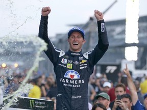 In this July 23, 2017, file photo, Kasey Kahne (5) celebrates winning the NASCAR Brickyard 400 auto race at Indianapolis Motor Speedway in Indianapolis. Kahne says he is retiring from full-time racing.