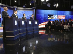 FILE In this May 9, 2018 file photo, from left Republicans gubernatorial candidates Dr. Jim Hines, Michigan state Sen. Patrick Colbeck, Lt. Gov. Brian Calley, and Attorney General Bill Schuette are seen during the GOP's first debate in Grand Raids, Mich.