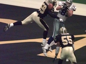 FILE - In this Dec. 24, 1999, file photo, New Orleans Saints linebacker Keith Mitchell (59) deflects a pass away Dallas Cowboys tightend David LaFleur (89) during the fourth quarter in New Orleans. Mitchell deflected the ball to teammate Mark Fields (55) who intercepted the pass, sealing the Saints 31-24 victory. On a routine tackle on Sept. 14, 2003, Keith Mitchell wound up flat on his back unable to move. His playing career was over. He had a spinal contusion. Now Mitchell is a certified yoga instructor with more than a decade of experience. He founded the Light It Up Foundation and the KM59 wellness movement that helps children, trauma survivors, first responders and veterans.