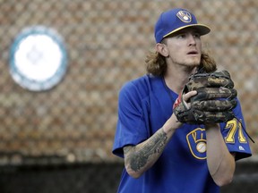 FILE - In this July 20, 2018, file photo, Milwaukee Brewers relief pitcher Josh Hader warms up before a baseball game against the Los Angeles Dodgers in Milwaukee. Whatever progress baseball has made promoting inclusion, it took a backseat recently. Years-old racist, misogynist and homophobic tweets from Milwaukee reliever Josh Hader were found during the All-Star Game.